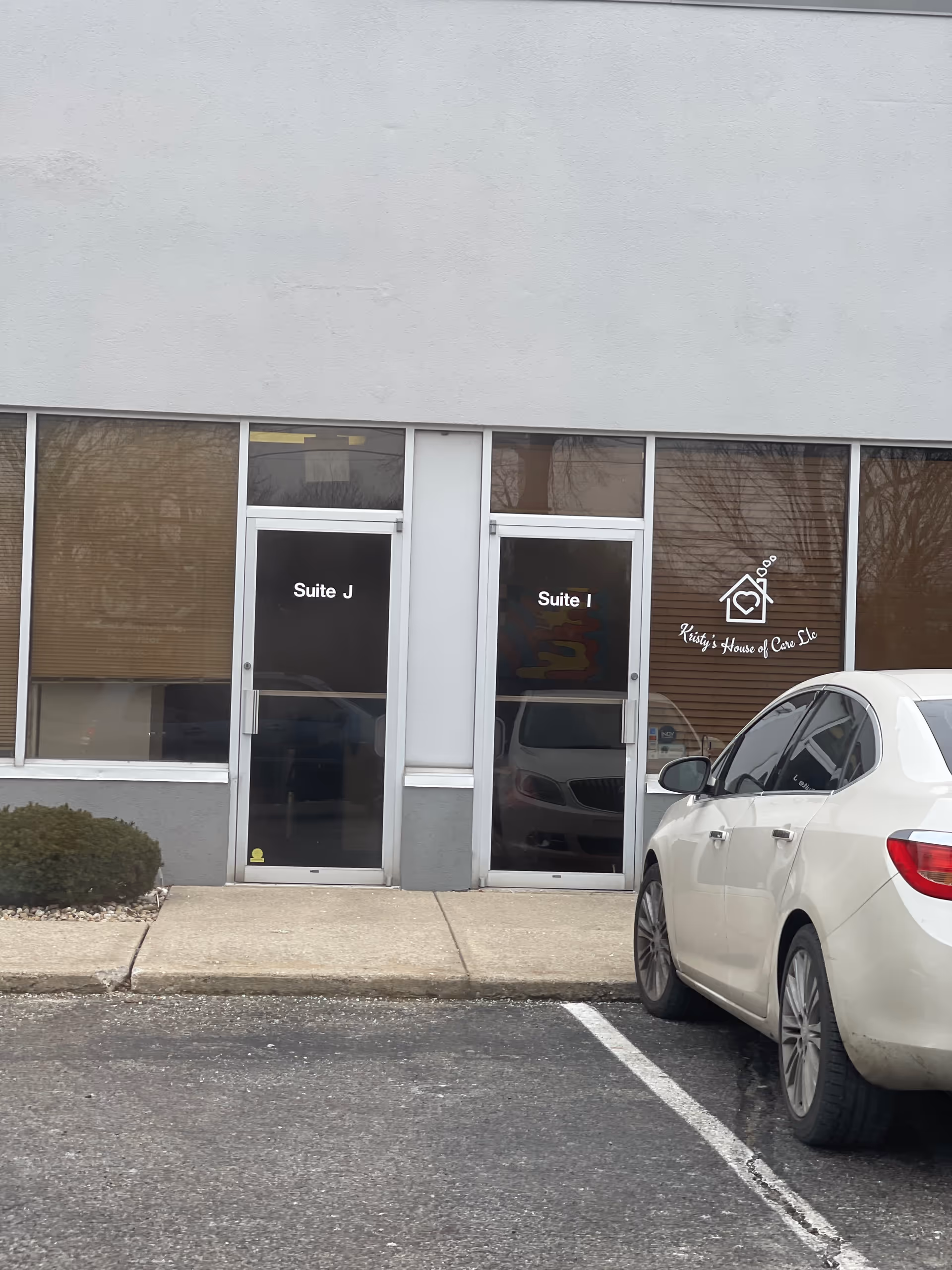 Exterior view of a building entrance with Suite J and Suite I doors.