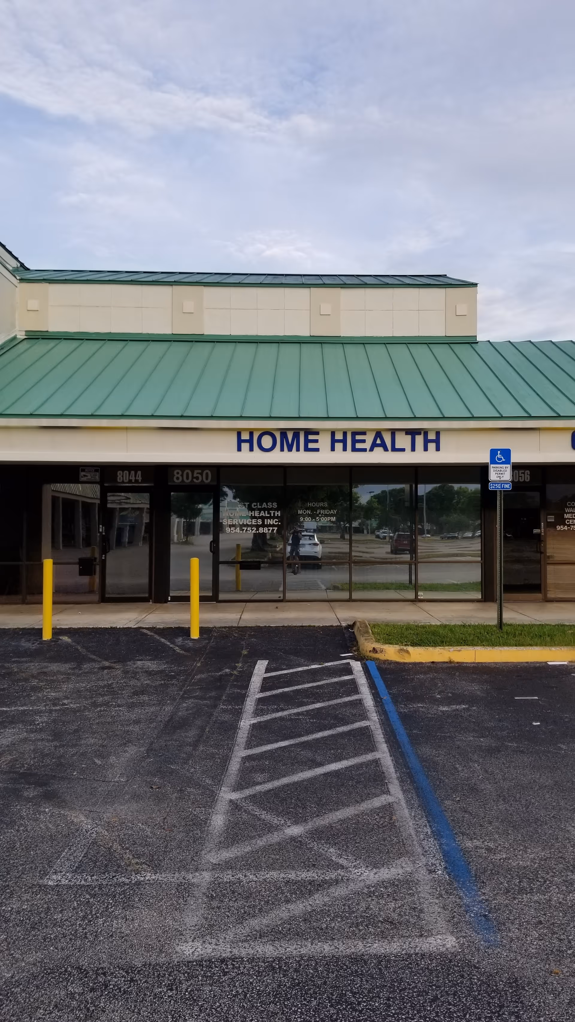Front view of a beige building with green roof and Home Health sign.