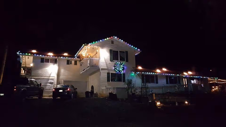 Exterior view of Acme Acres Adult Foster Care building at night with colorful lights