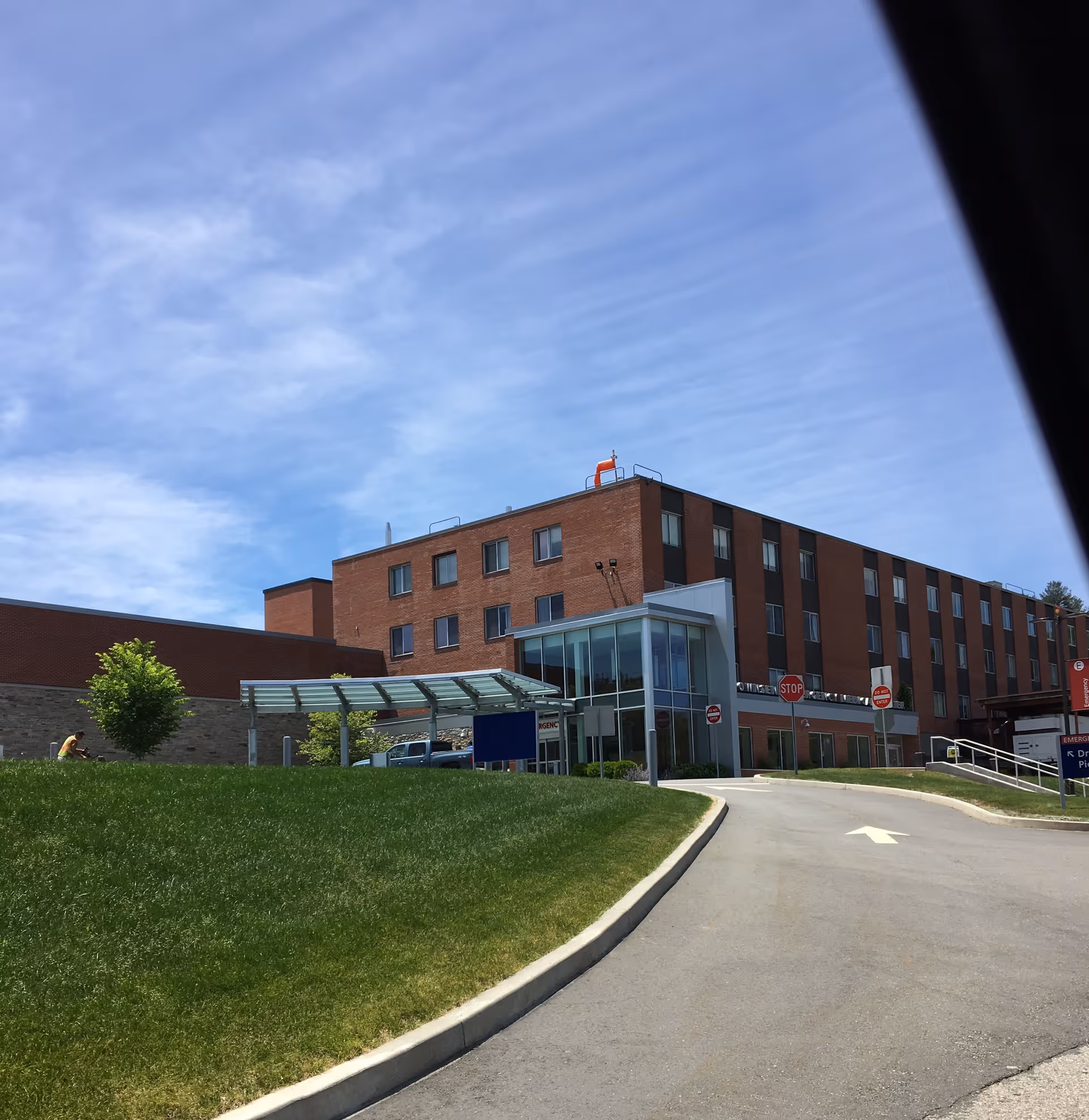 Day Kimball Healthcare building with brick exterior and glass entrance under blue sky