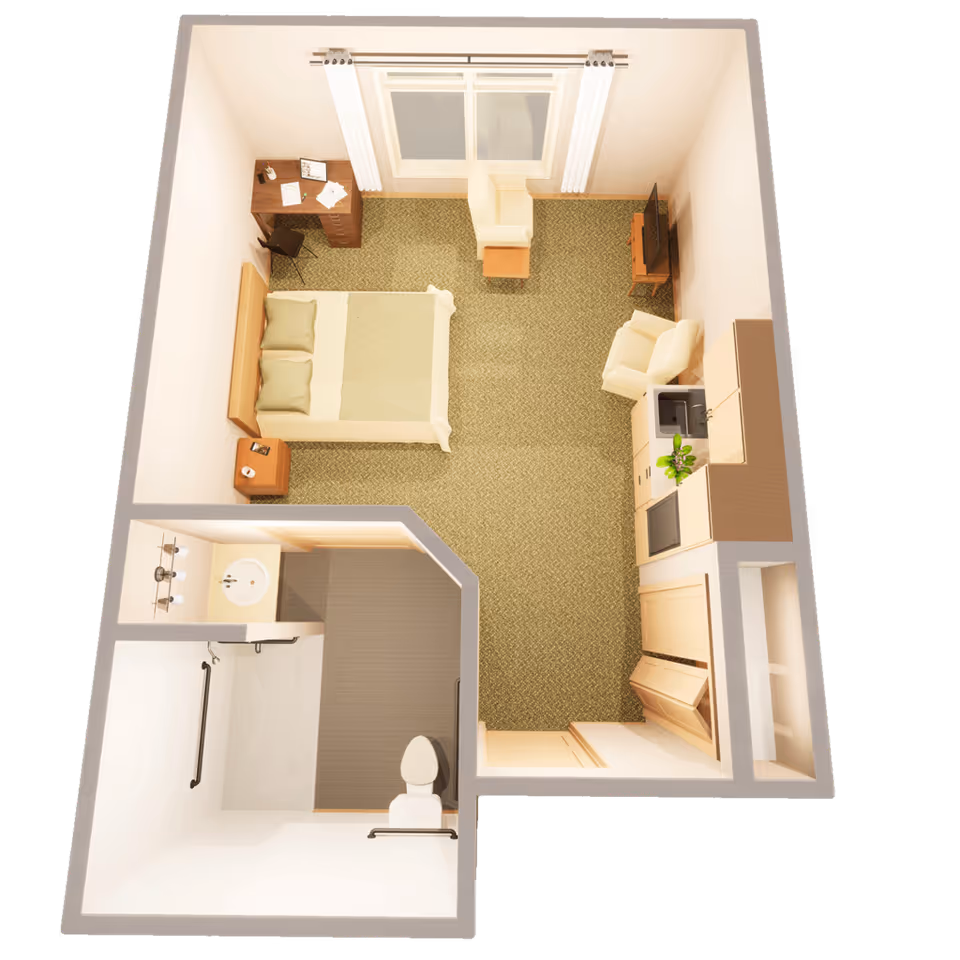 Top-down view of a small studio apartment layout featuring a bedroom area with a bed, nightstand, desk, and chair. The room also includes a sitting area with two armchairs and a TV on a stand. There is a kitchenette with a sink, cabinets, and a small refrigerator. The bathroom has a toilet, sink, and a walk-in shower with grab bars.