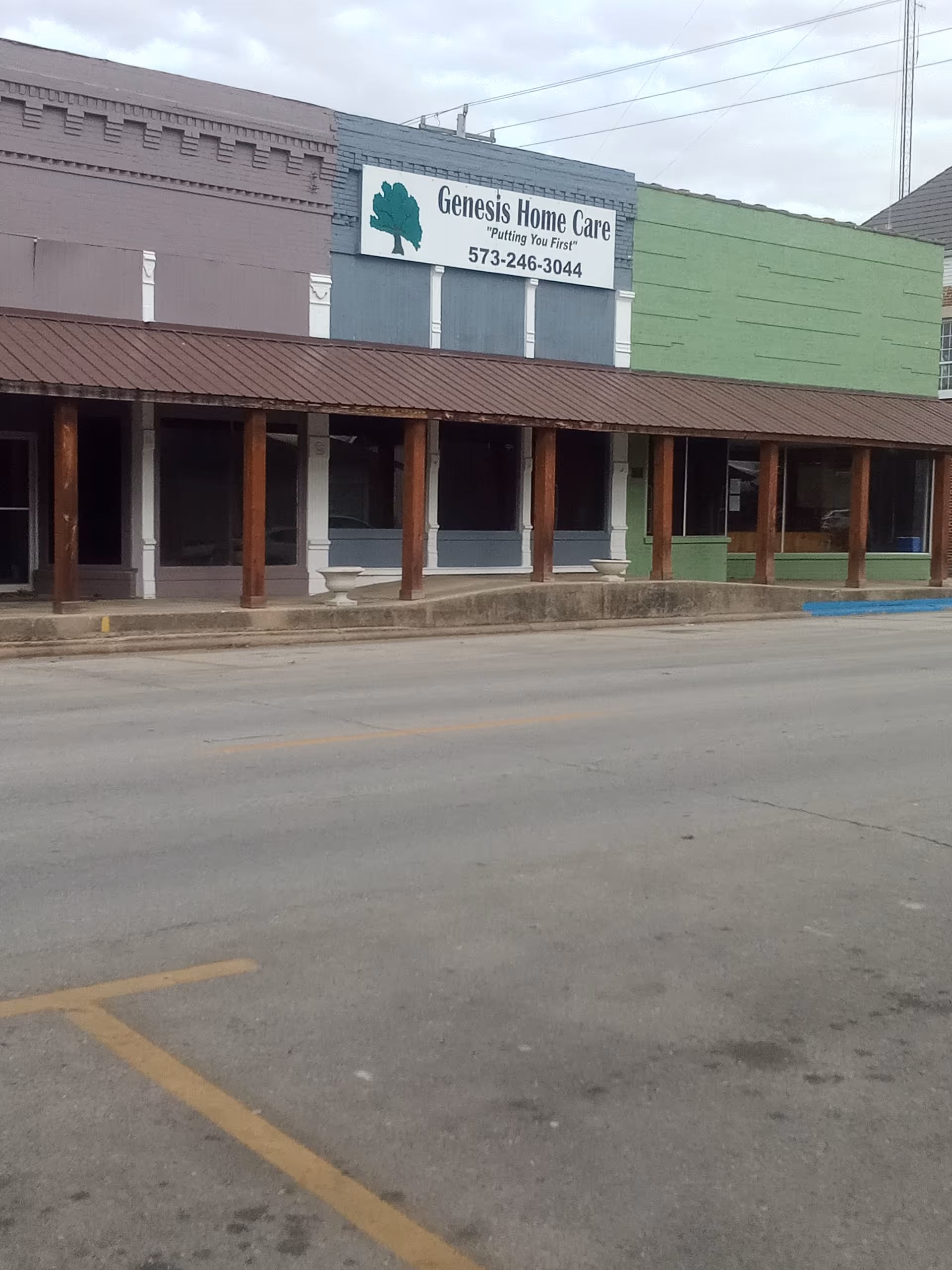 Exterior view of Genesis Home Care storefront with sign and parking lot.
