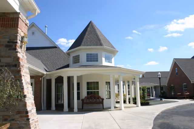 Exterior view of Woodlands at Hampton Woods with a circular porch and tower.