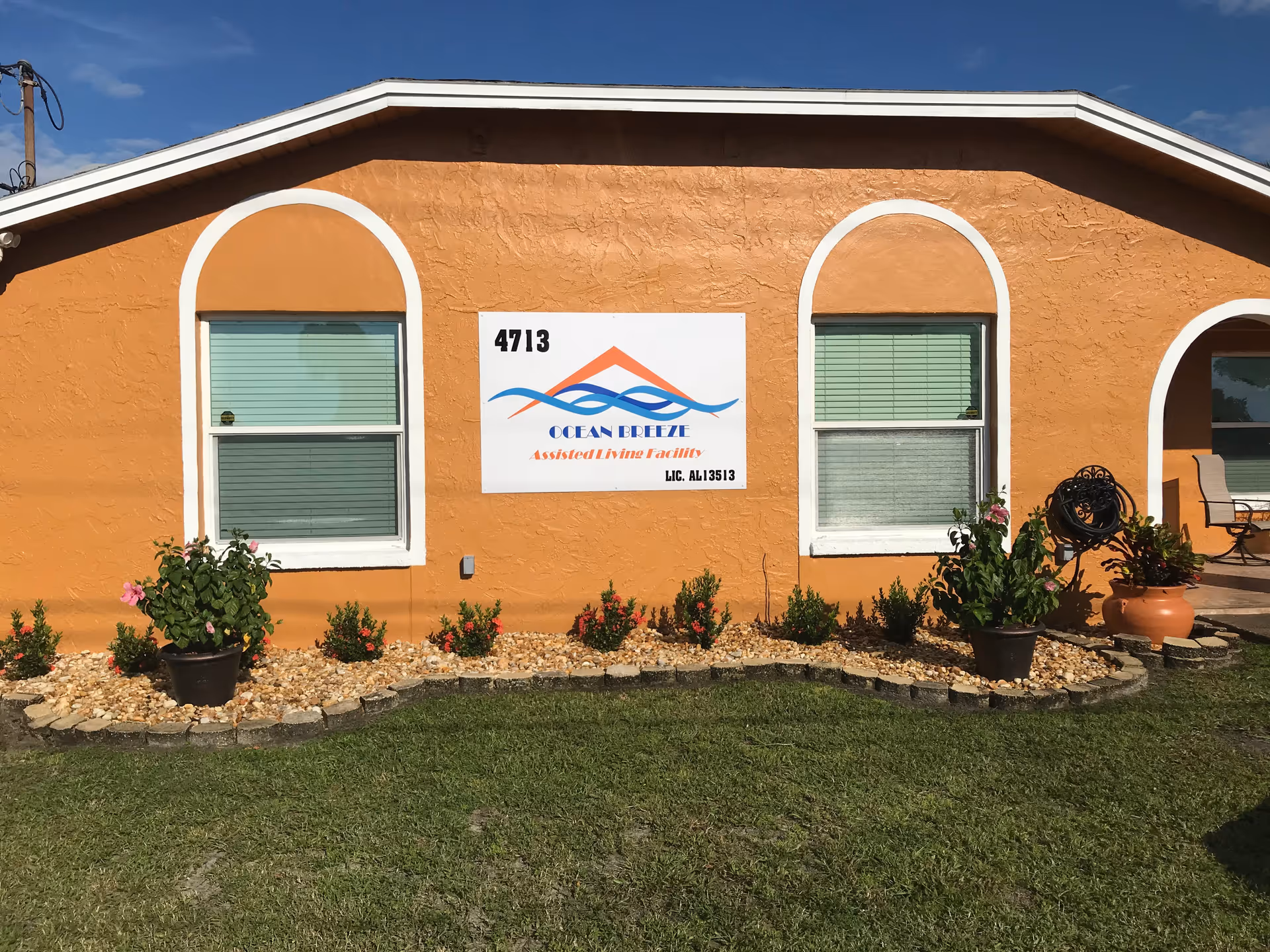 Ocean Breeze Assisted Living Facility facade with sign, windows, and landscaped front yard.