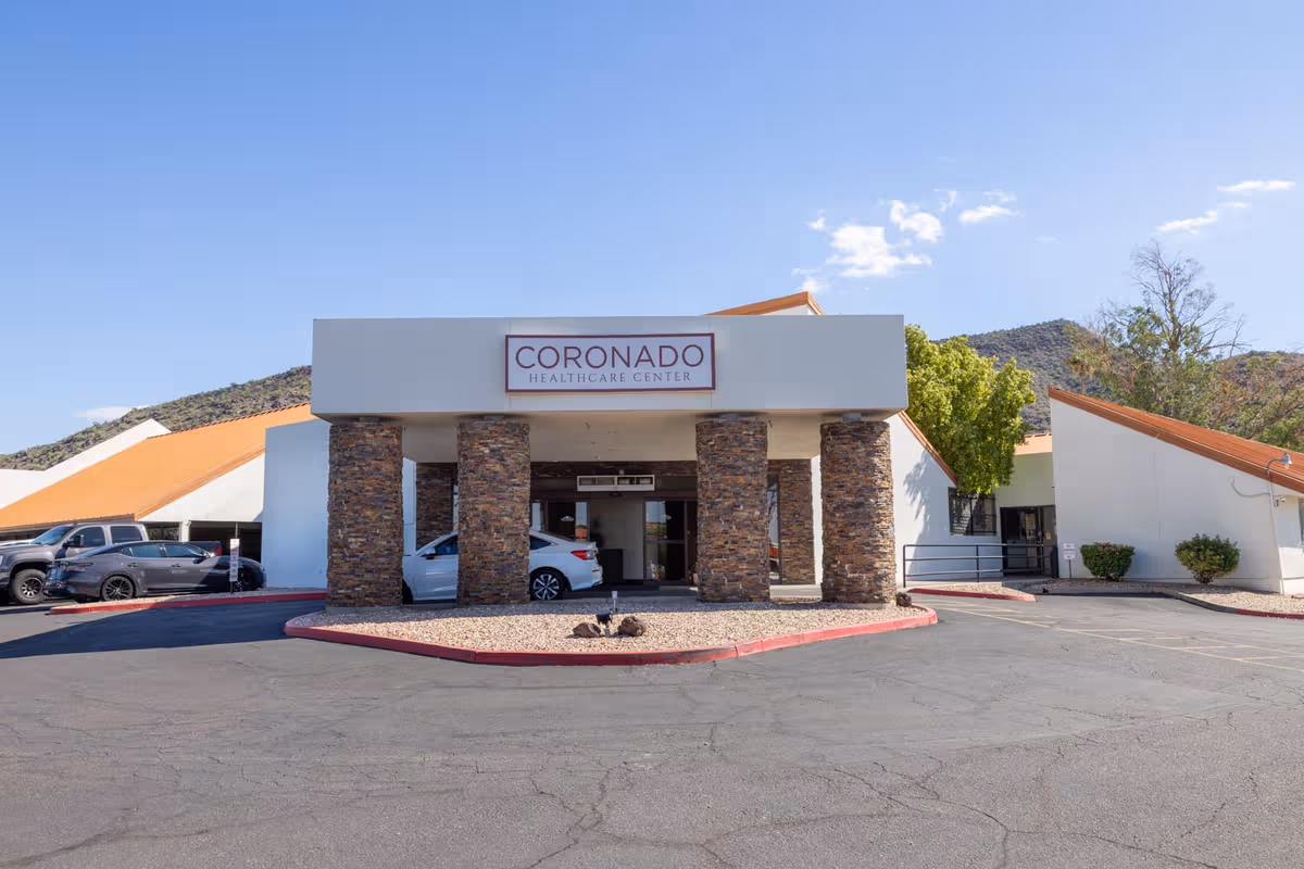 Exterior view of Coronado Healthcare Center's front entrance with stone pillars