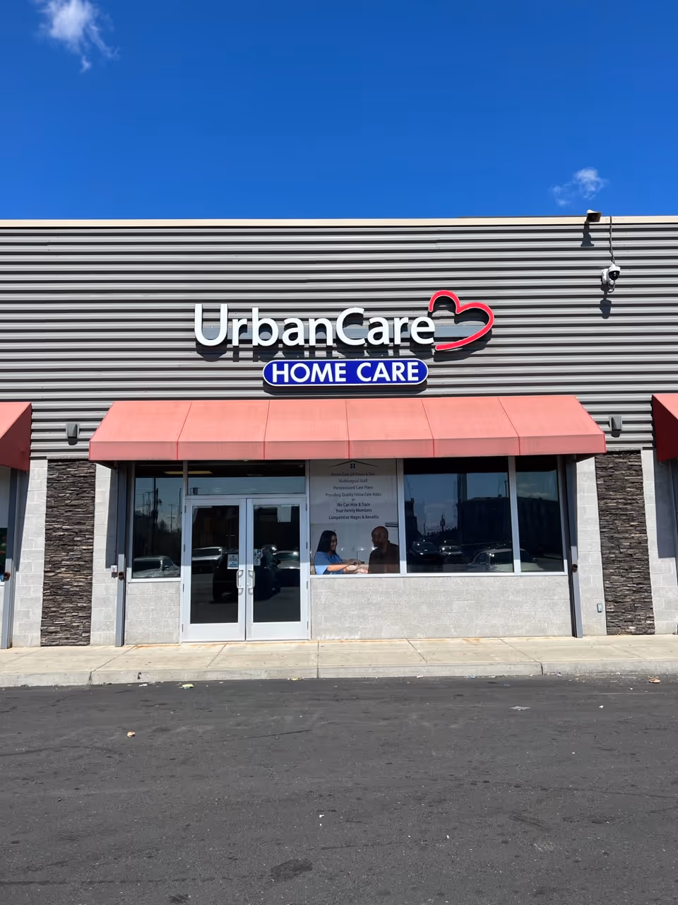 Street view of UrbanCare Home Care storefront with pink awning and front windows