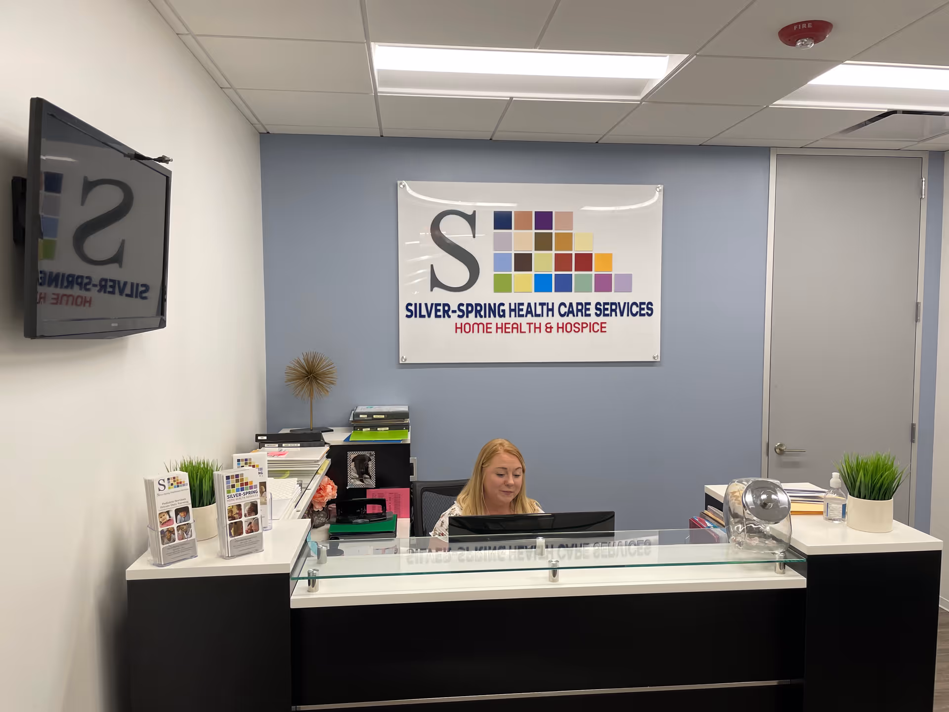 Reception desk inside a Silver-Spring Health Care Services office with a receptionist