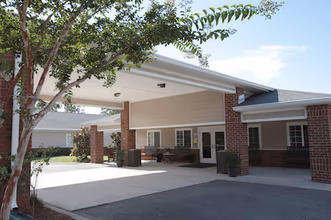 Exterior view of St James Health and Rehabilitation Center entrance with brick columns and covered drop-off.