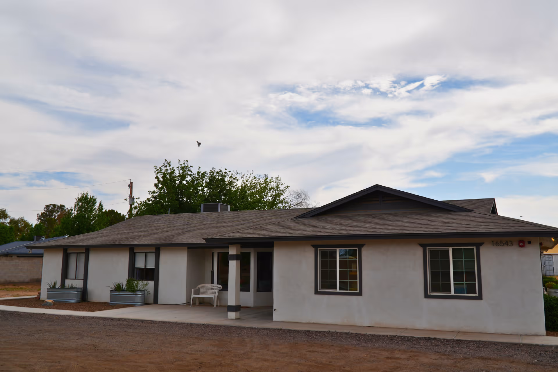 Front exterior of a single-story assisted living facility with a covered entrance.