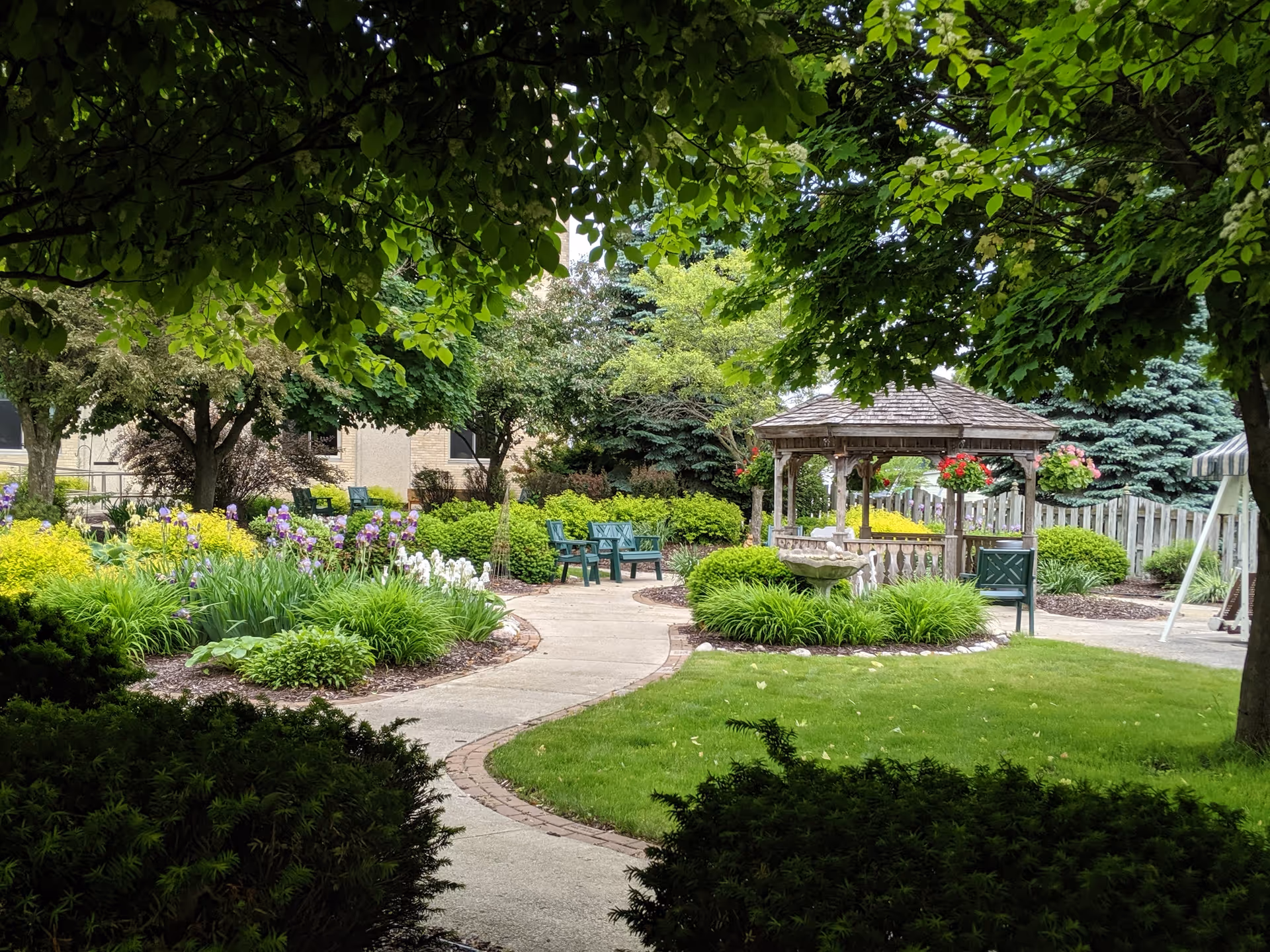 Shady Lane outdoor garden courtyard with gazebo, benches, and winding paths.