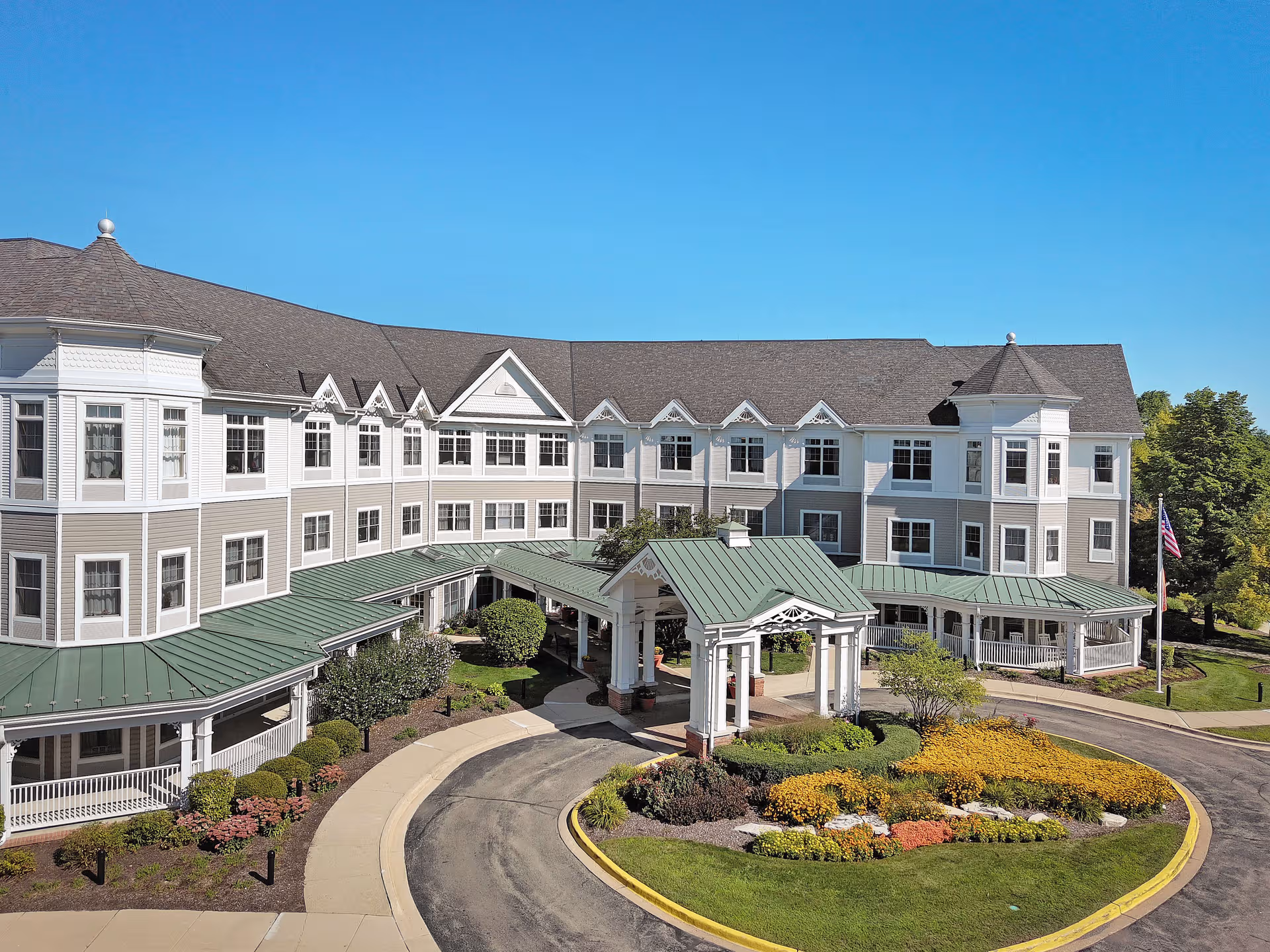 Sunrise of Naperville North exterior: large multi-story building with circular driveway and landscaped grounds.