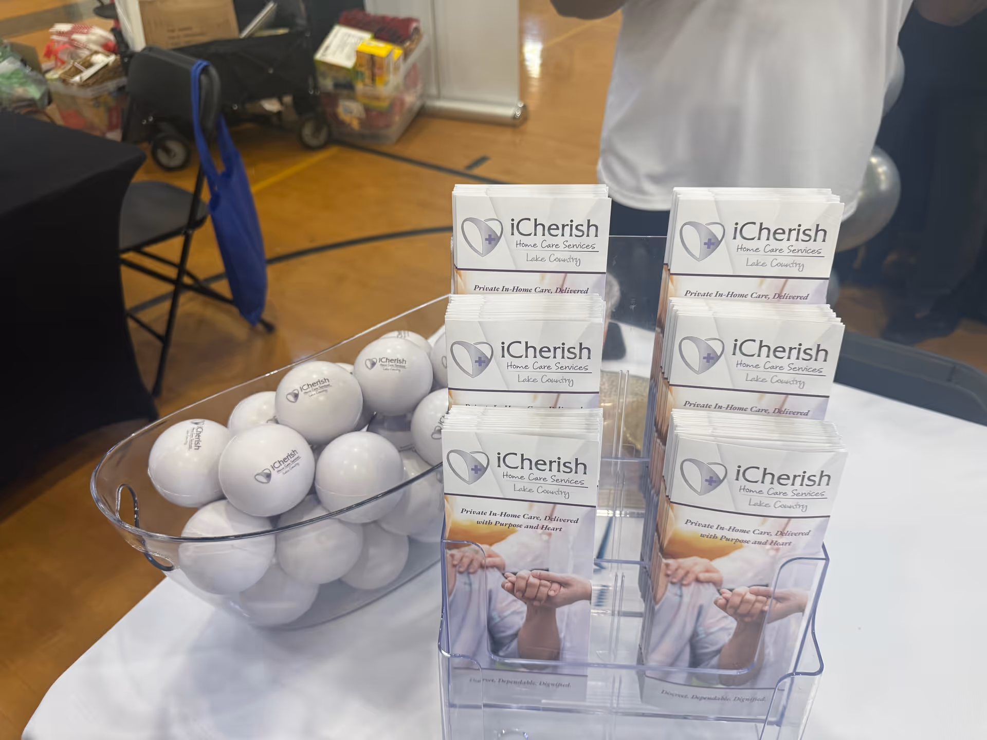 Promotional brochures and white balls sit on a table inside a senior care facility.