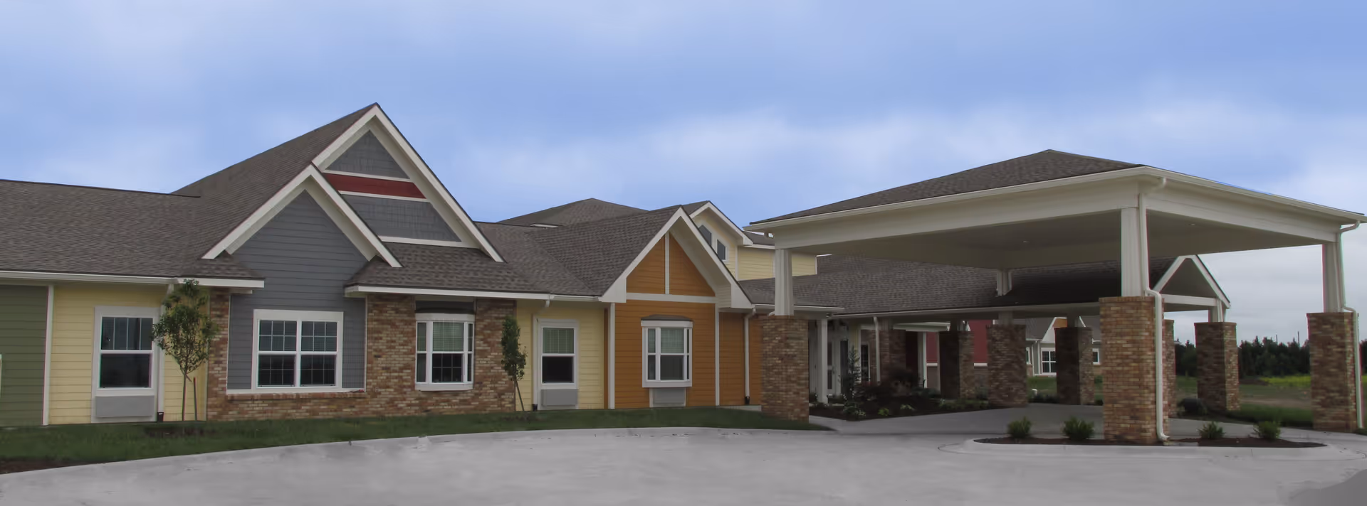 Front view of Sunflower Terrace by Bethany Village, a single-story senior living facility with colorful facade.