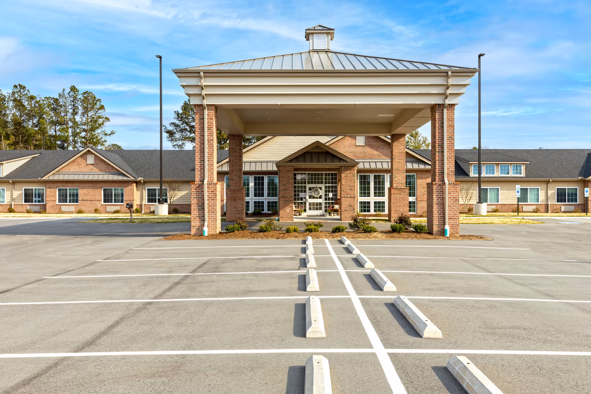 Front view of The Landings of Albemarle with brick entrance and covered portico.