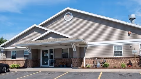 Exterior view of ElderONE North Park PACE Center building with entrance and parking lot.
