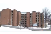 Snow-covered exterior view of Pleasant Acres Nursing & Rehabilitation Center, a brick multi-wing facility.