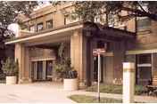 Exterior view of Alameda Oaks Nursing Center with brick façade, covered entrance, and planters.