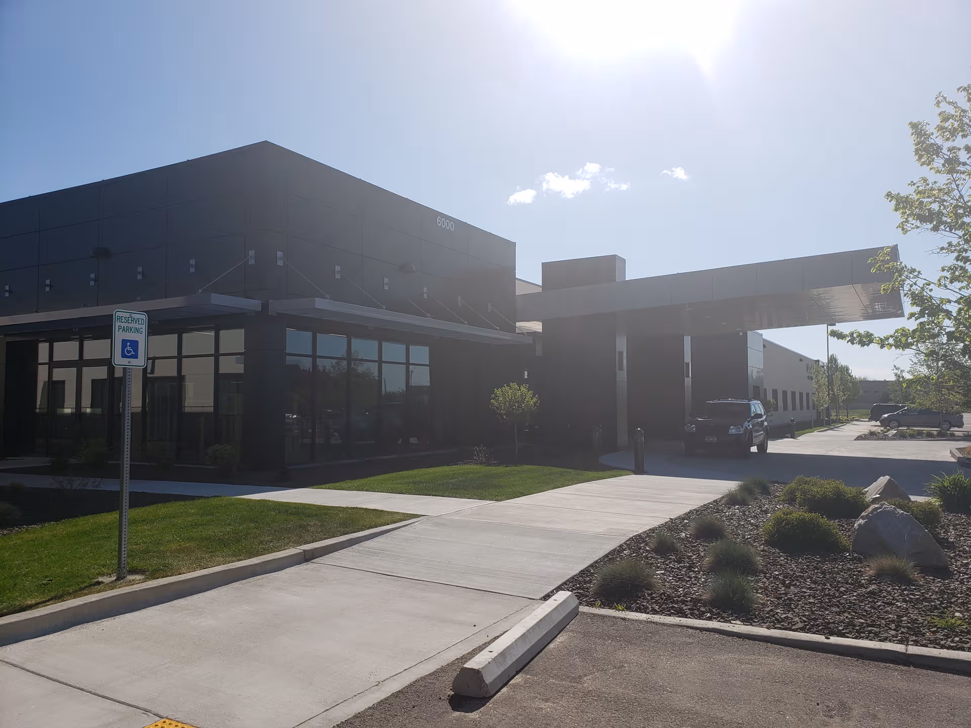 Modern Cascadia of Boise senior living facility exterior with glass storefront and parking.