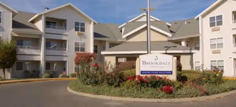 Exterior view of Brookdale Canyon Lakes building with landscaped entrance and sign.