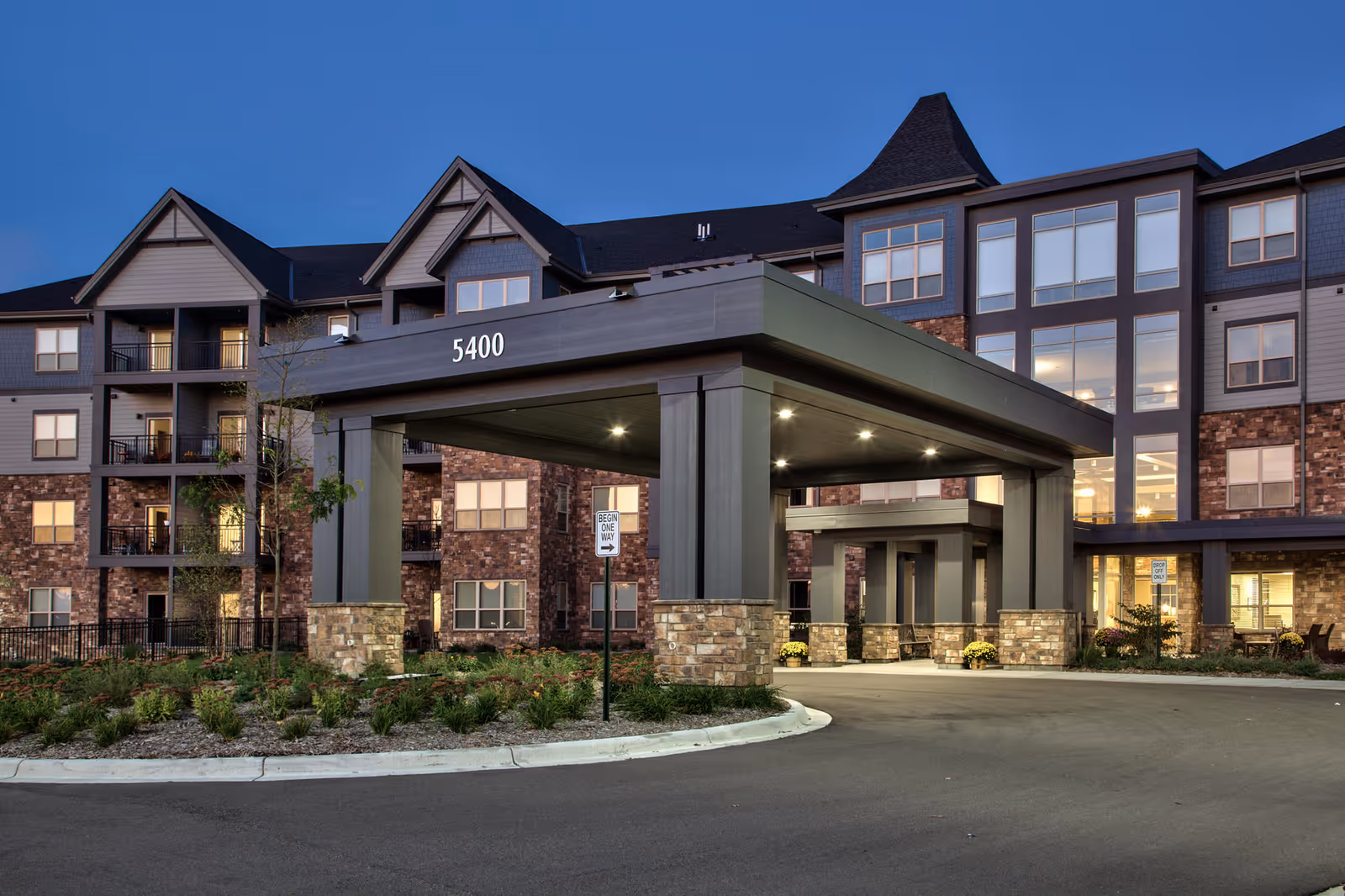 Exterior view of Orchard Path senior living facility with covered entrance.