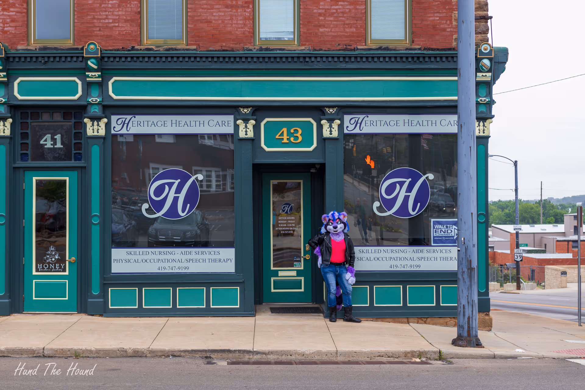 Front view of Heritage Health Care Mansfield storefront with a costumed character standing at the door.