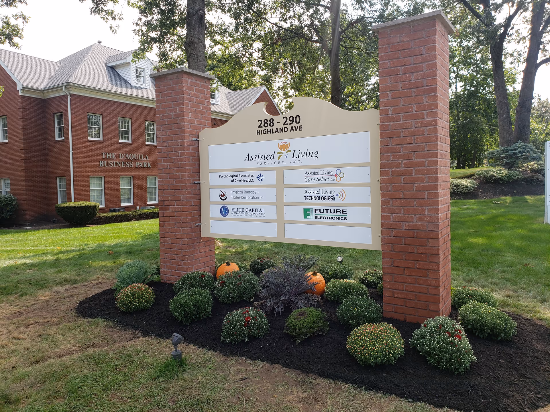 Exterior entrance sign for Assisted Living with brick columns and landscaping