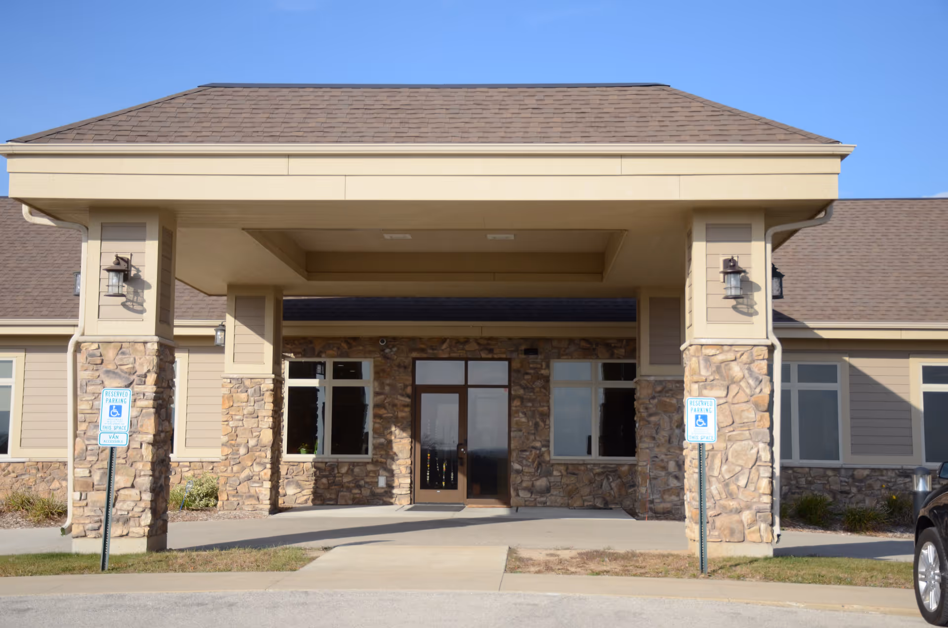 Front view of Just Like Home Adult Day Center entrance with stone facade.