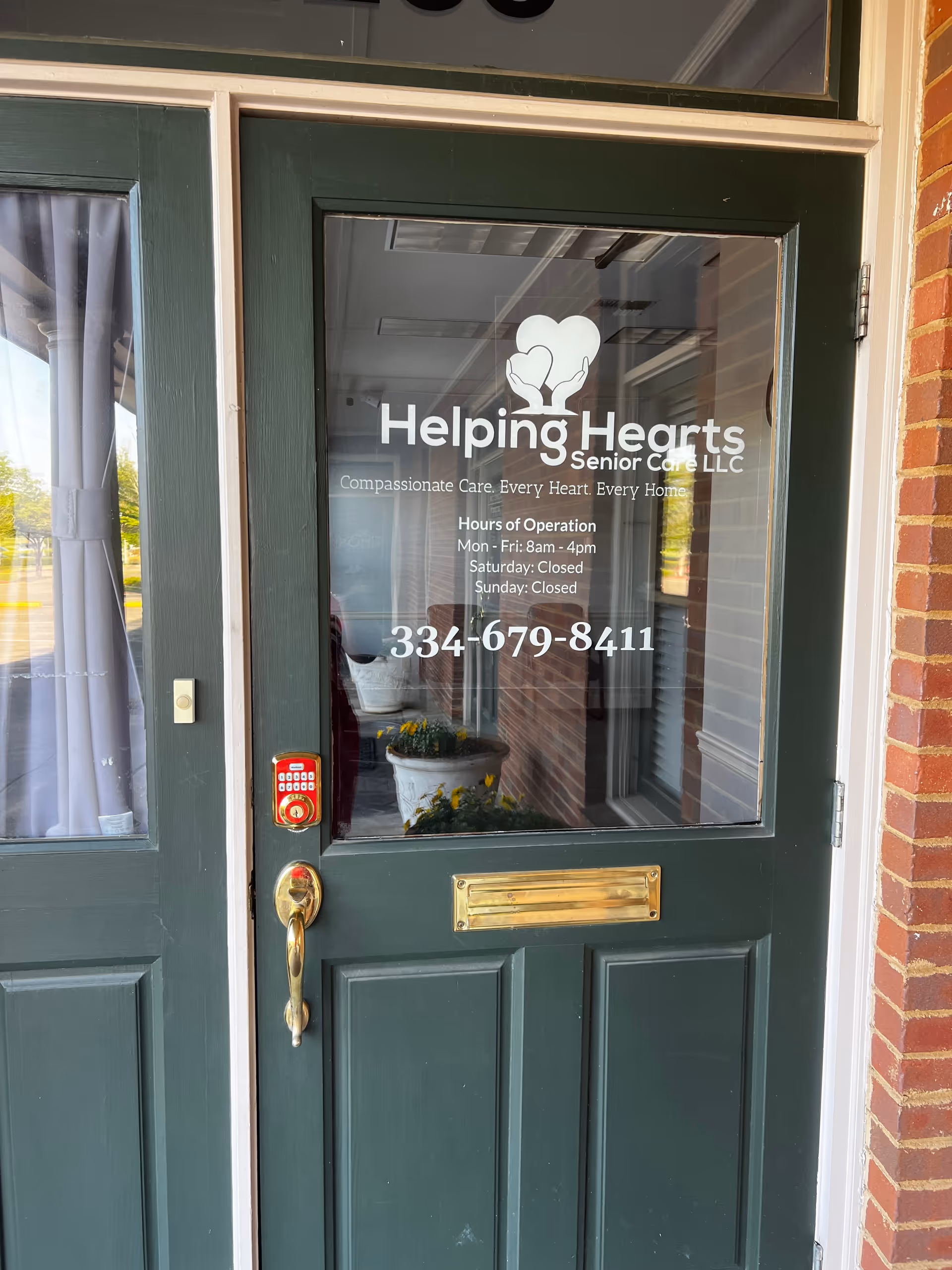Green front door with Helping Hearts Senior Care logo and contact information.