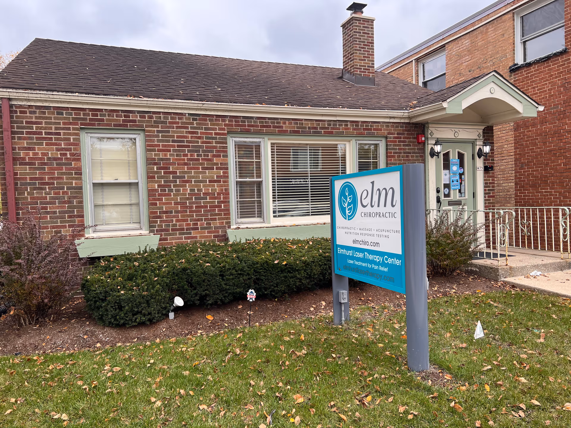Brick building exterior with Elm Chiropractic sign and front entrance