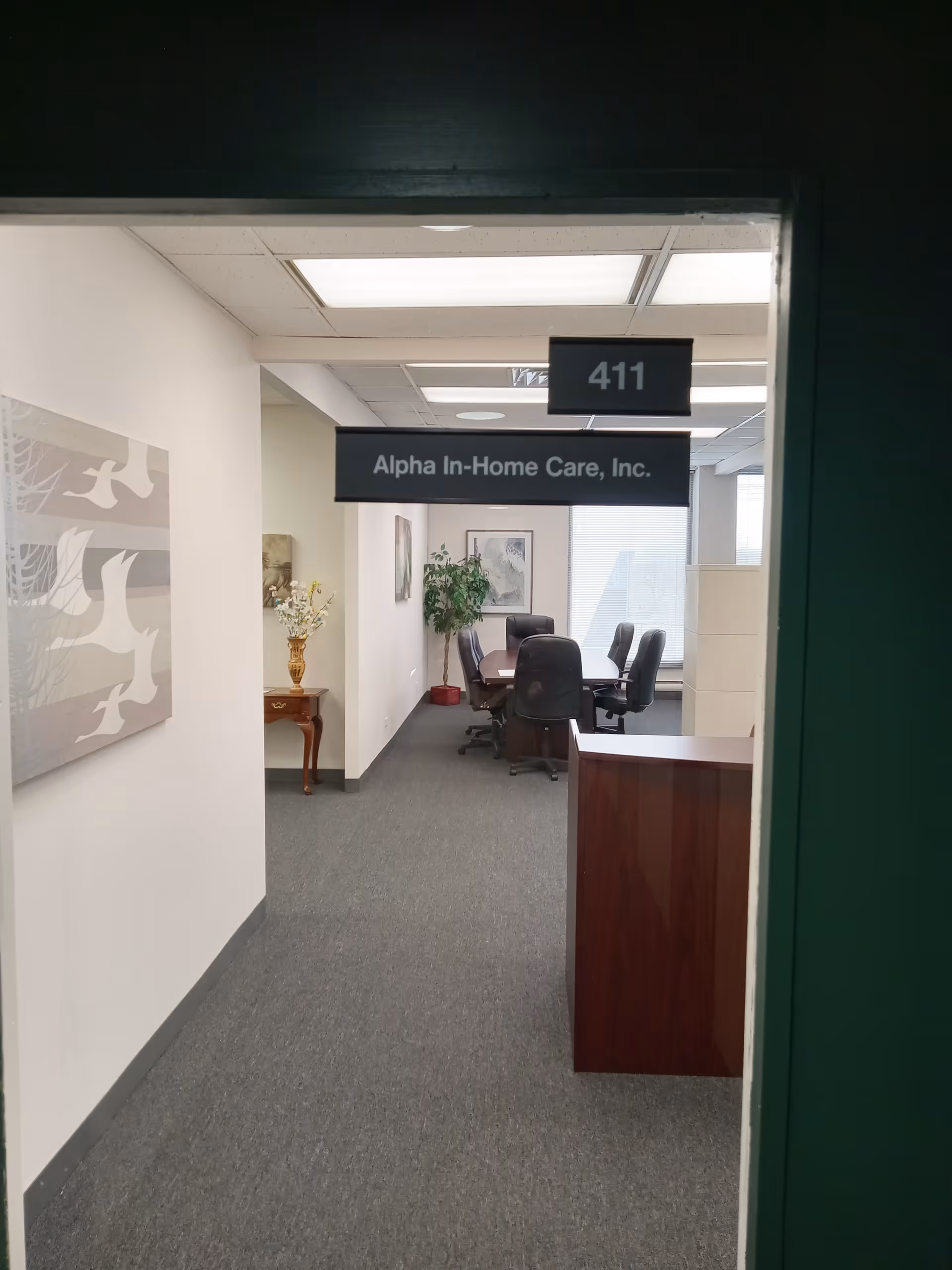 Interior hallway of Alpha In-Home Care, Inc., with a conference area.