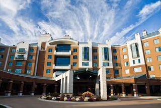 Exterior view of Knapp Home senior living facility with a circular driveway and landscaped entrance.