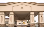 Exterior view of Aperion Care Oak Lawn entrance with columns and a branded sign