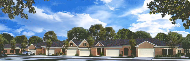 Row of single-story senior living facility buildings with garages and trees.