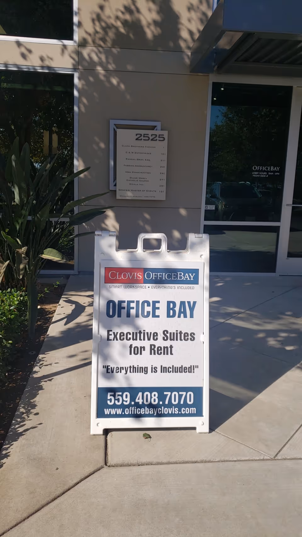 Exterior storefront with an office rental sign and building entrance.