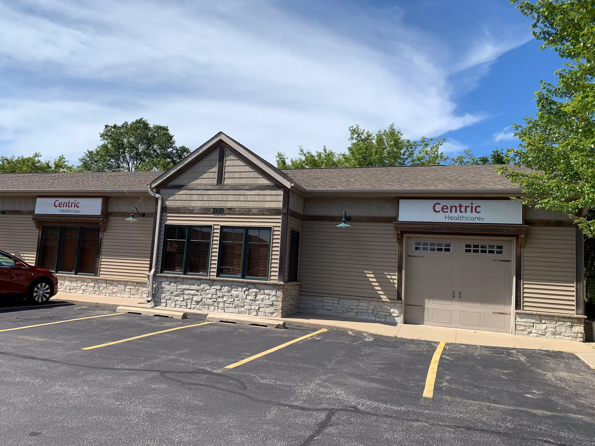 Exterior view of Centric Healthcare building in Rochester, MN with beige siding.