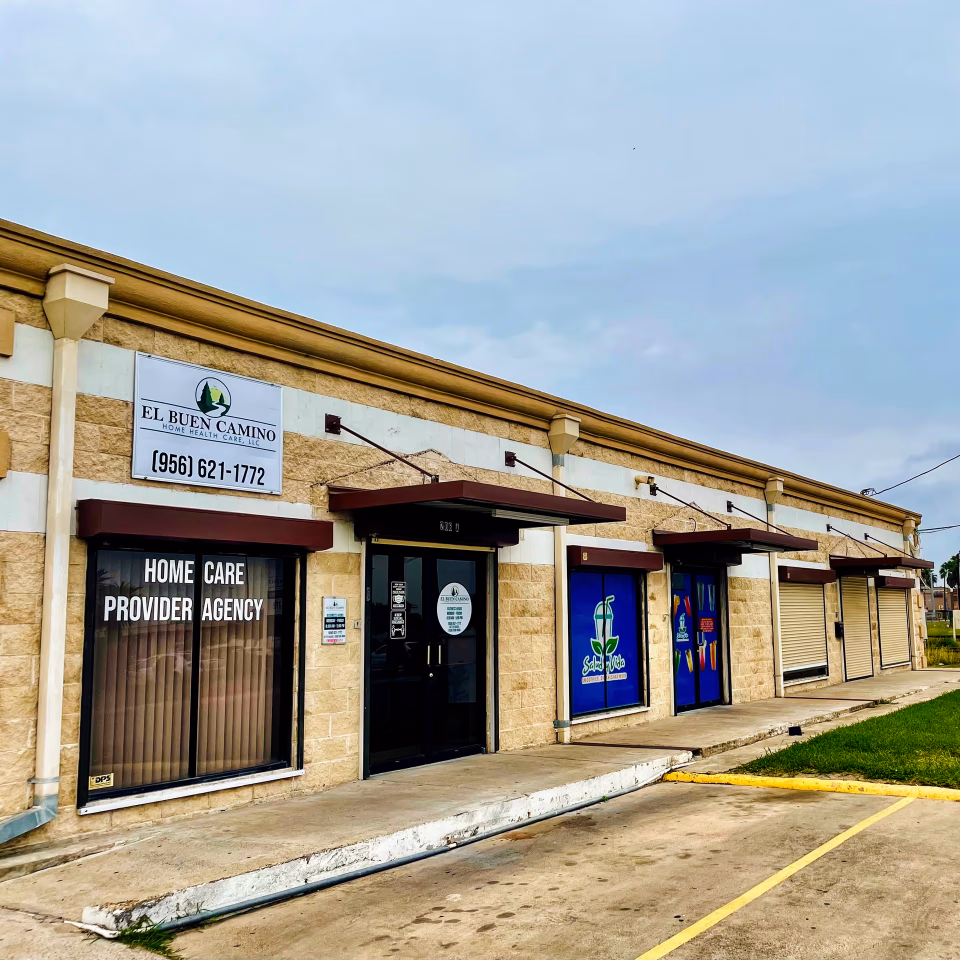 Exterior view of a single-story storefront with El Buen Camino Home Health Care signage and doors.