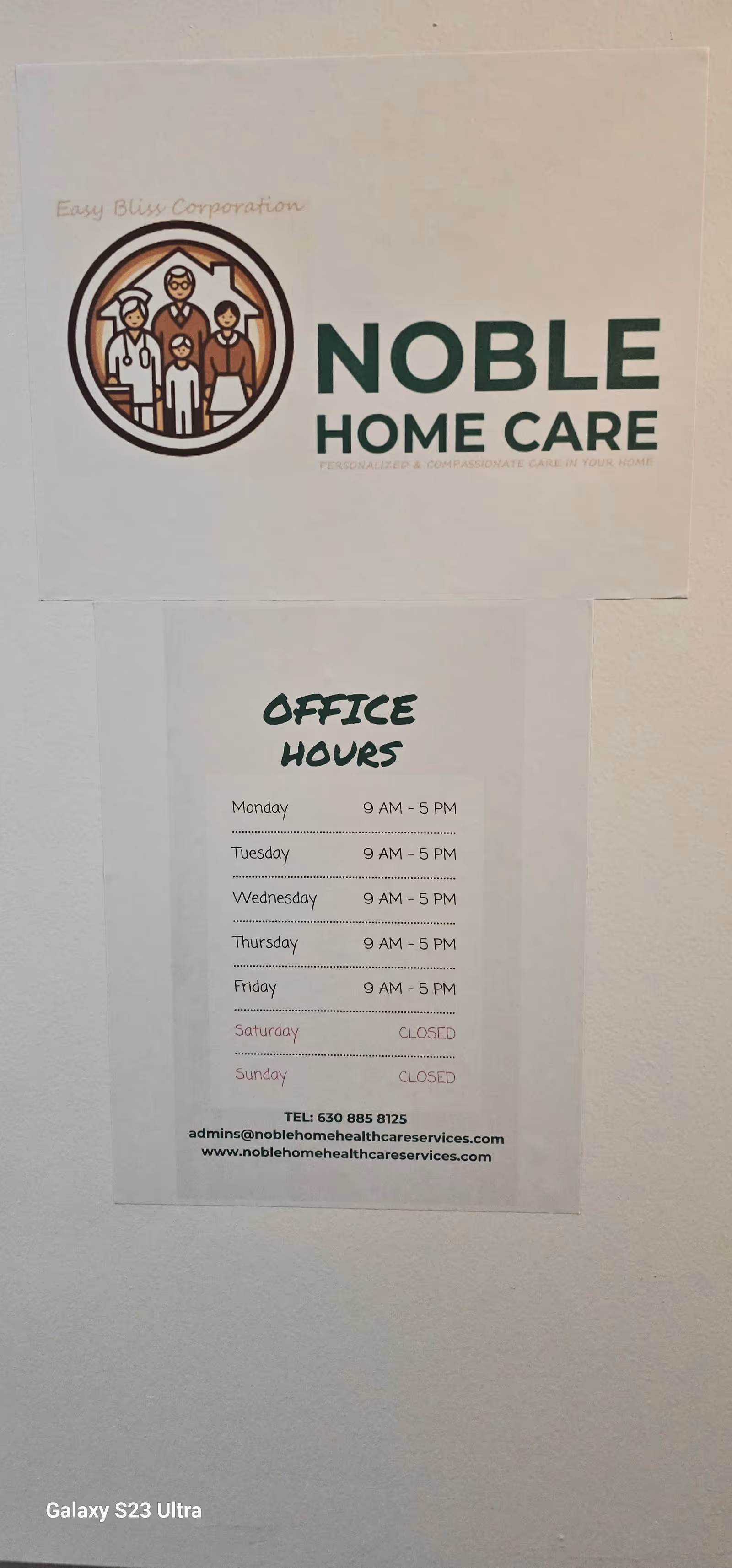 Noble Home Care logo with office hours posted on a white interior wall.