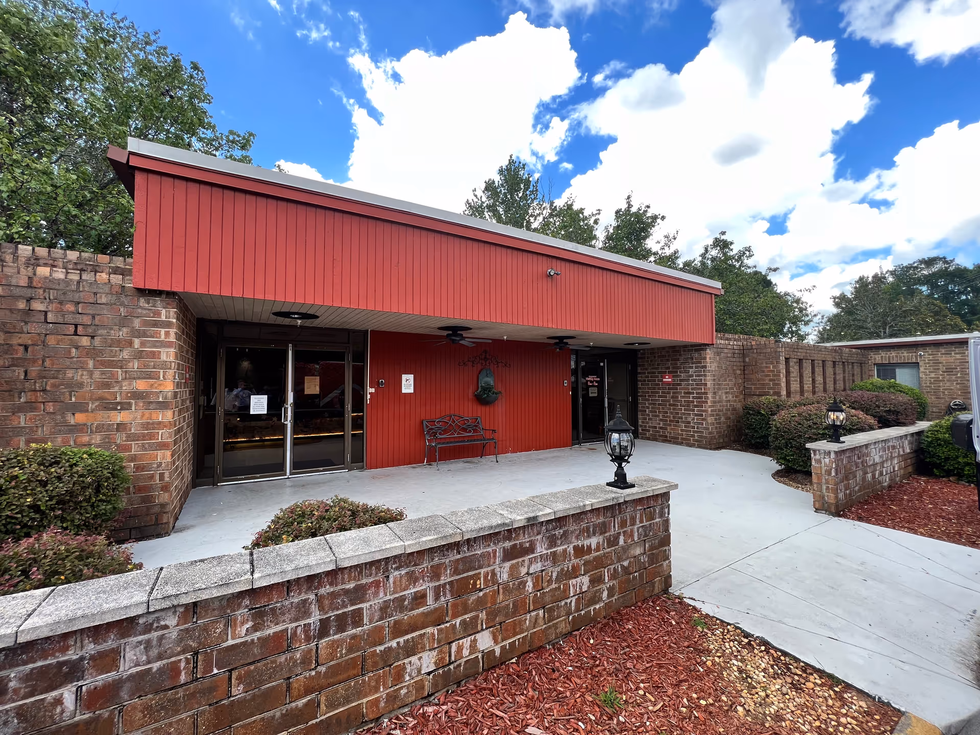 Front entrance of River Towne Center with red awning and brick exterior