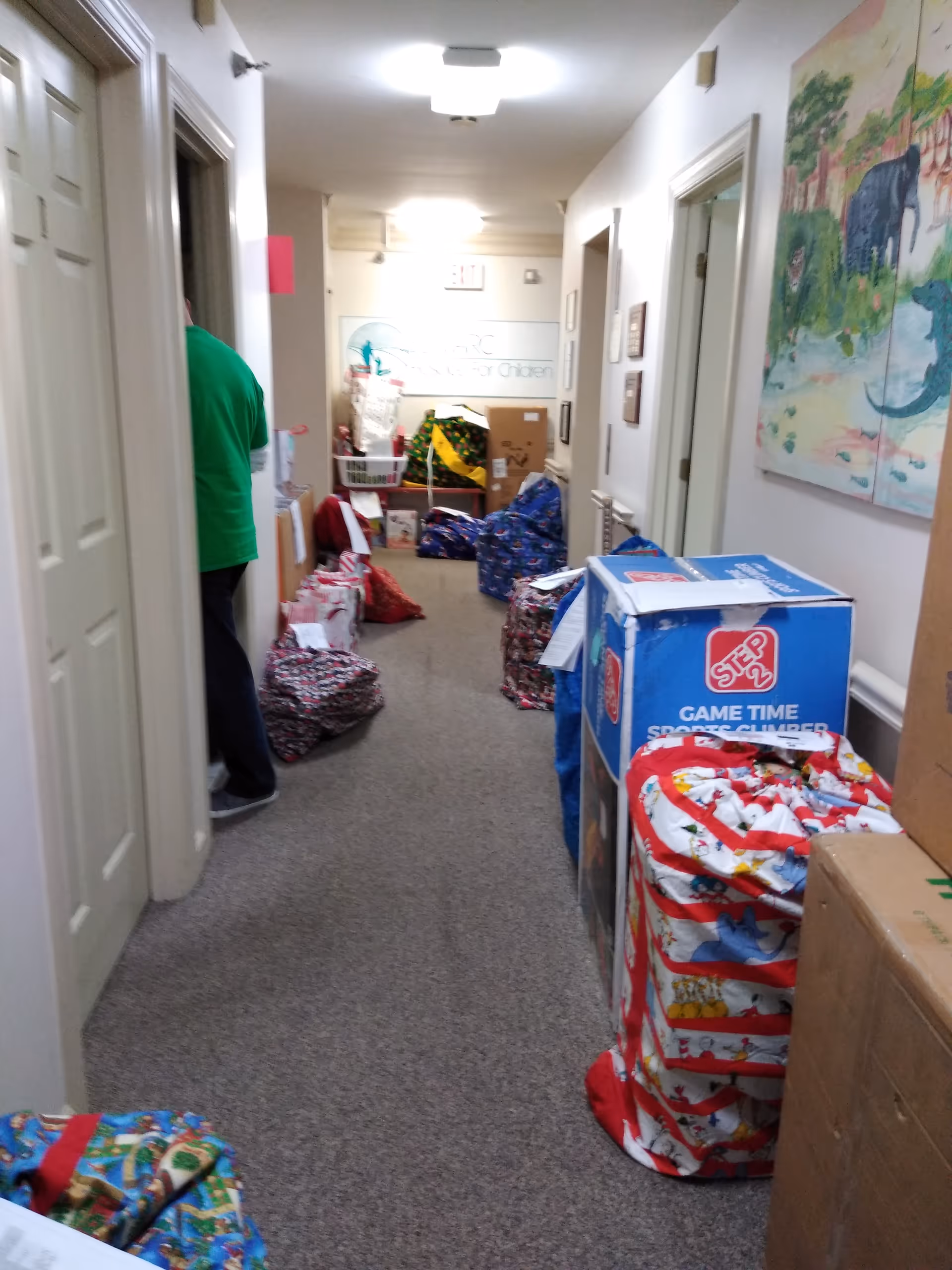 Edmarc senior living hallway cluttered with gifts, bags, and boxes along the walls.