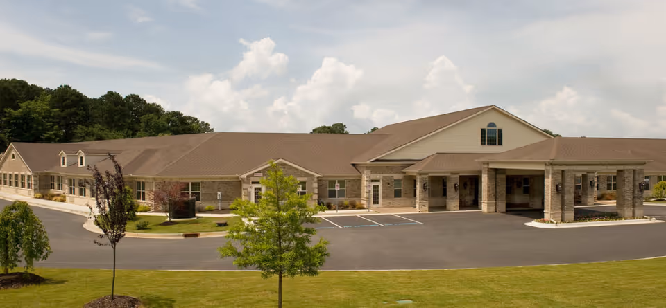 Wide view of Country Square senior living facility exterior with entrance and parking.