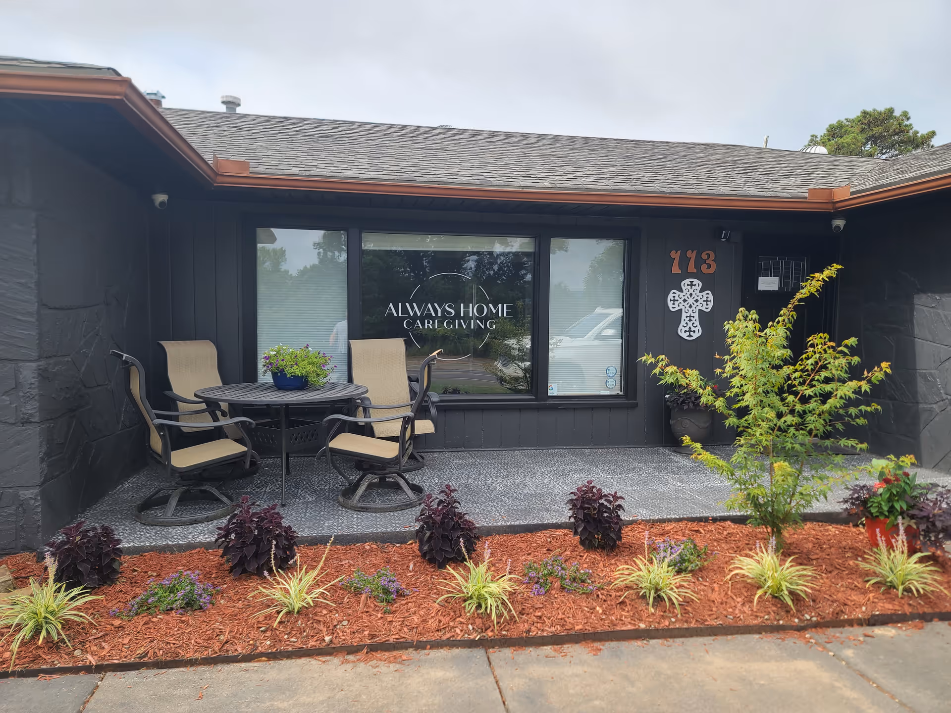 Exterior view of Always Home Caregiving with outdoor seating and landscaped front.