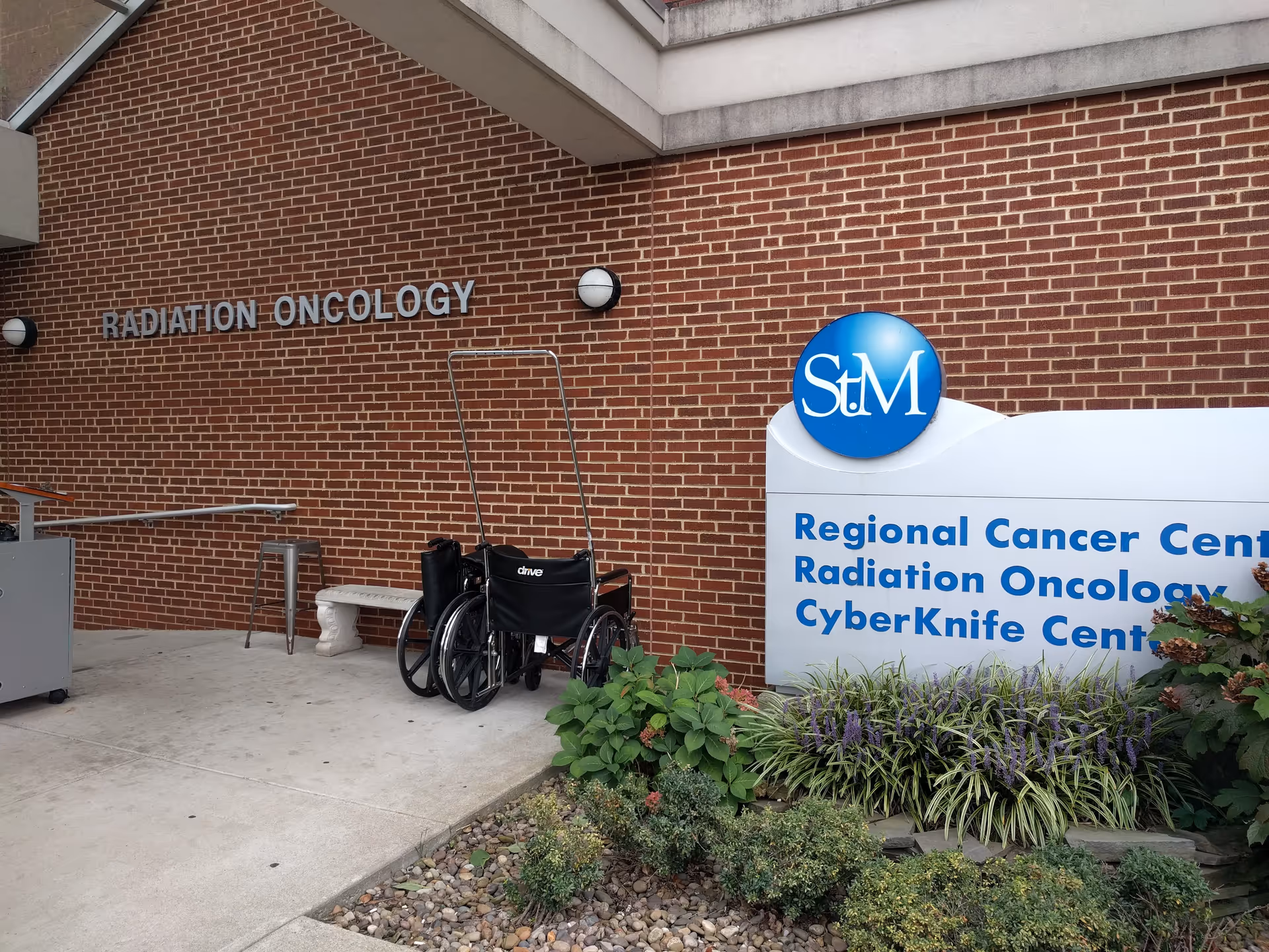Exterior of St. Mary's Medical Center Cancer Center with wheelchairs and landscaping.