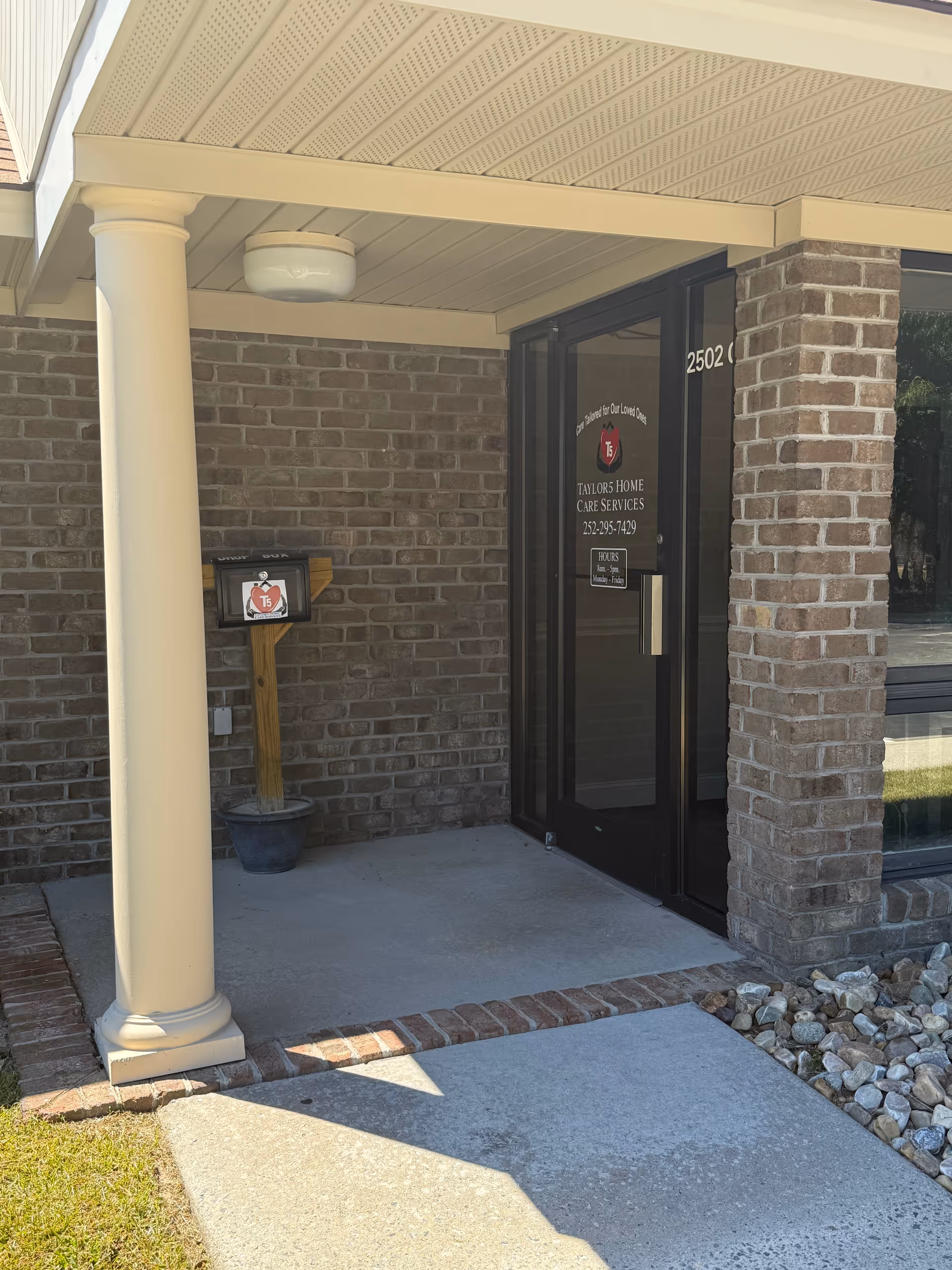 Exterior entrance of Taylor5 Home Care Services, brick building with a columned porch