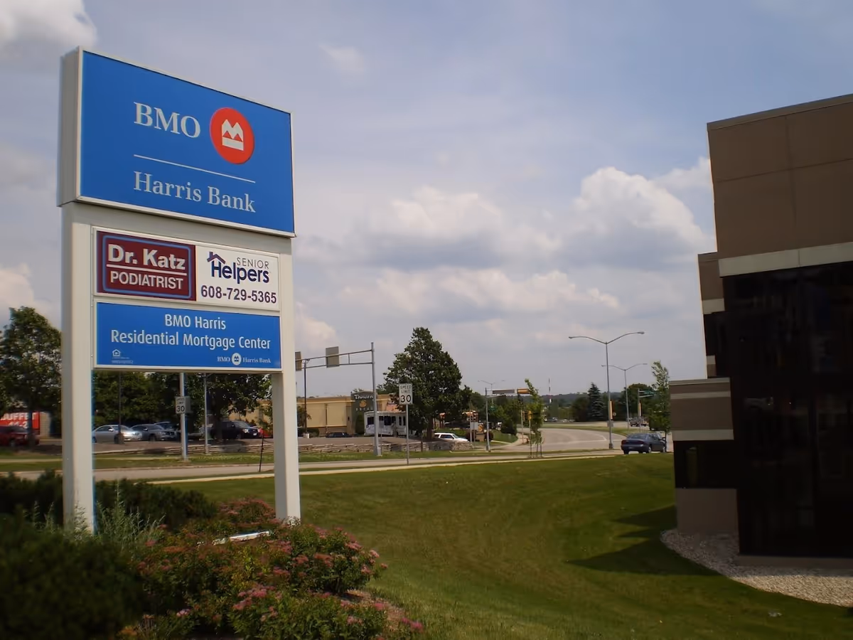 Exterior view of a Senior Helpers Madison sign with nearby bank signage