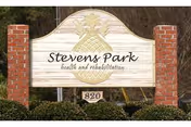 Wooden Stevens Park health and rehabilitation sign between brick pillars.