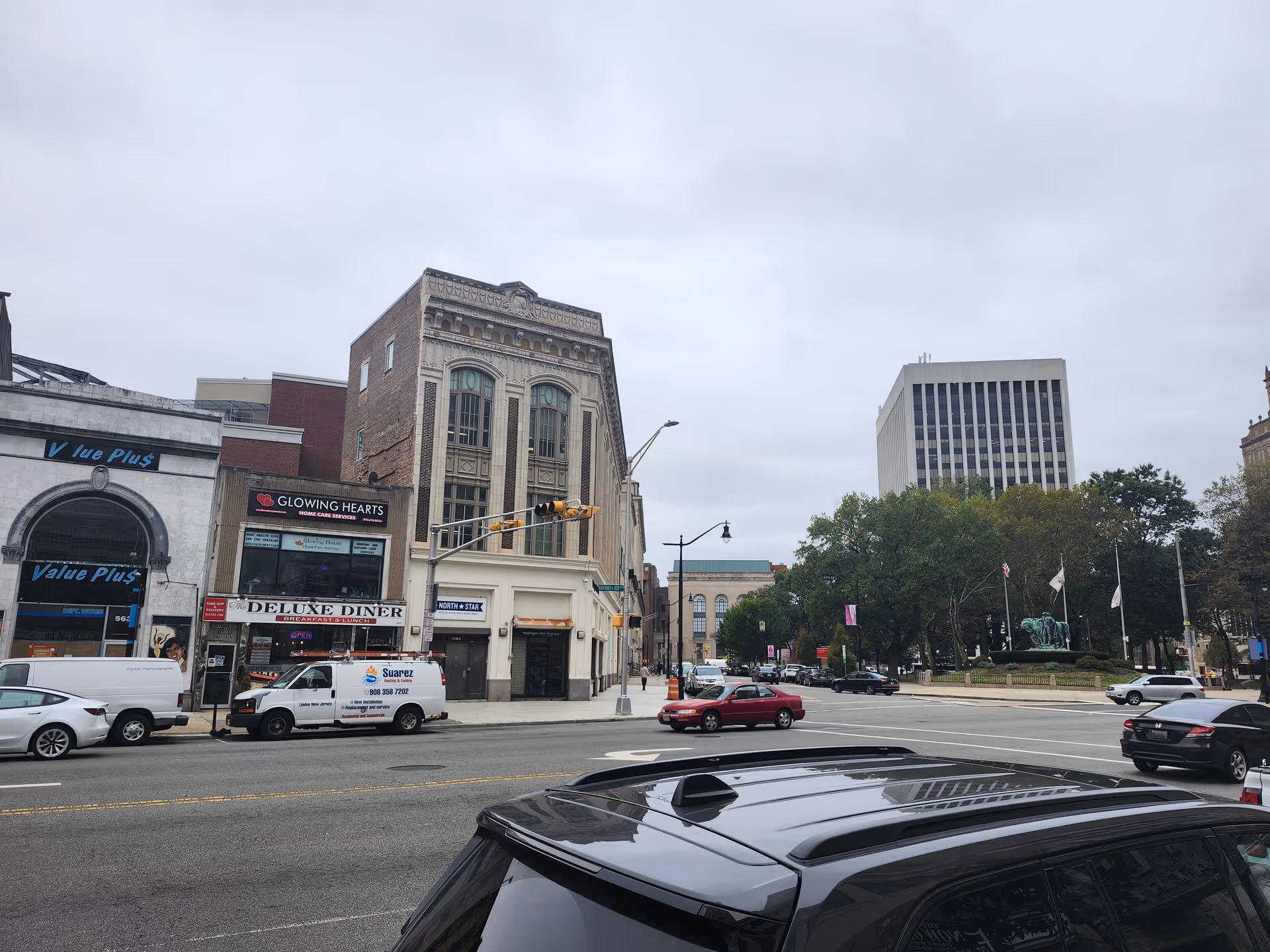 A storefront street view with Glowing Hearts Home Care Services signage on a row of buildings.