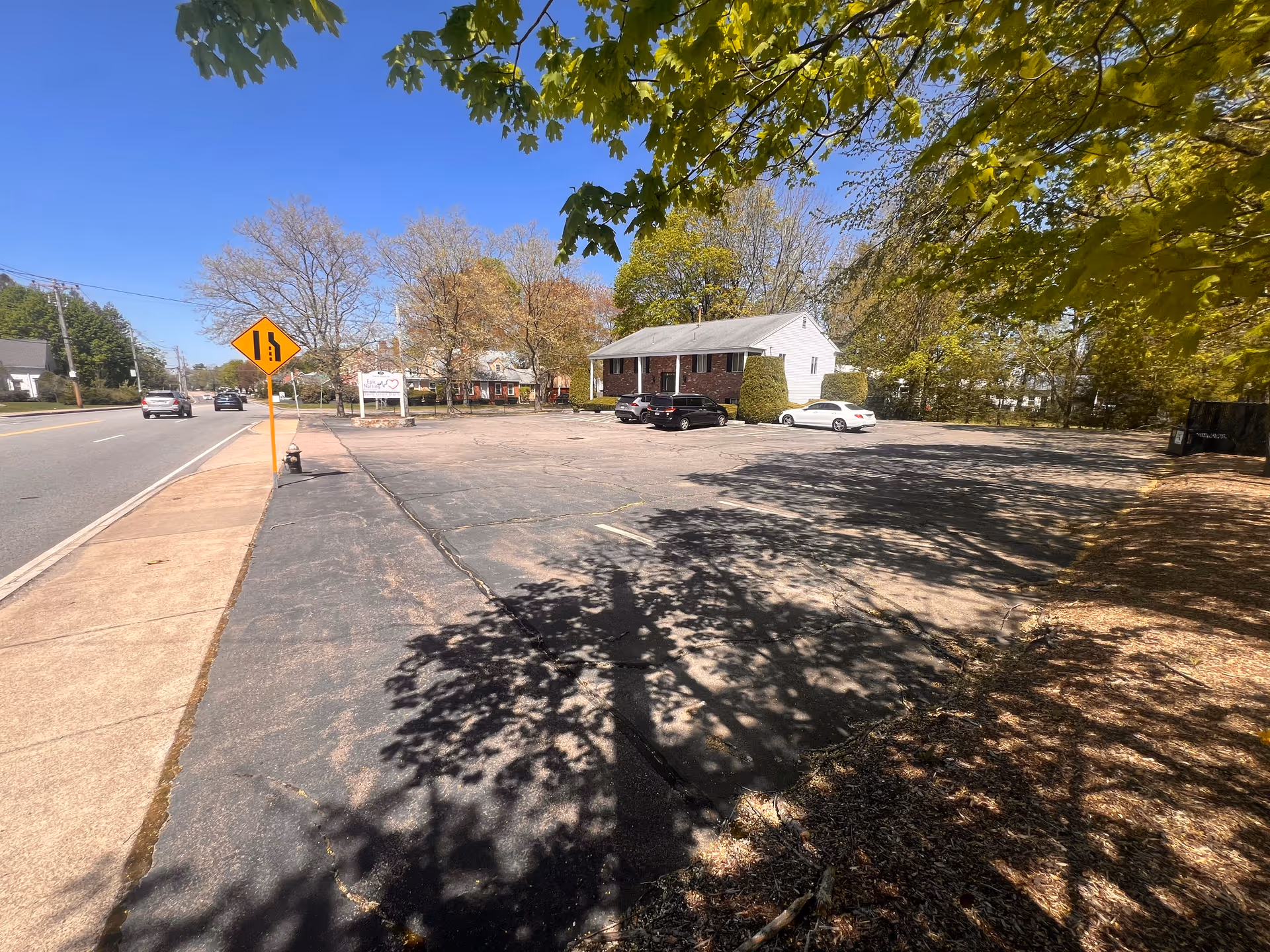 Exterior of Epic Nursing Services LLC building with a parking lot and trees.