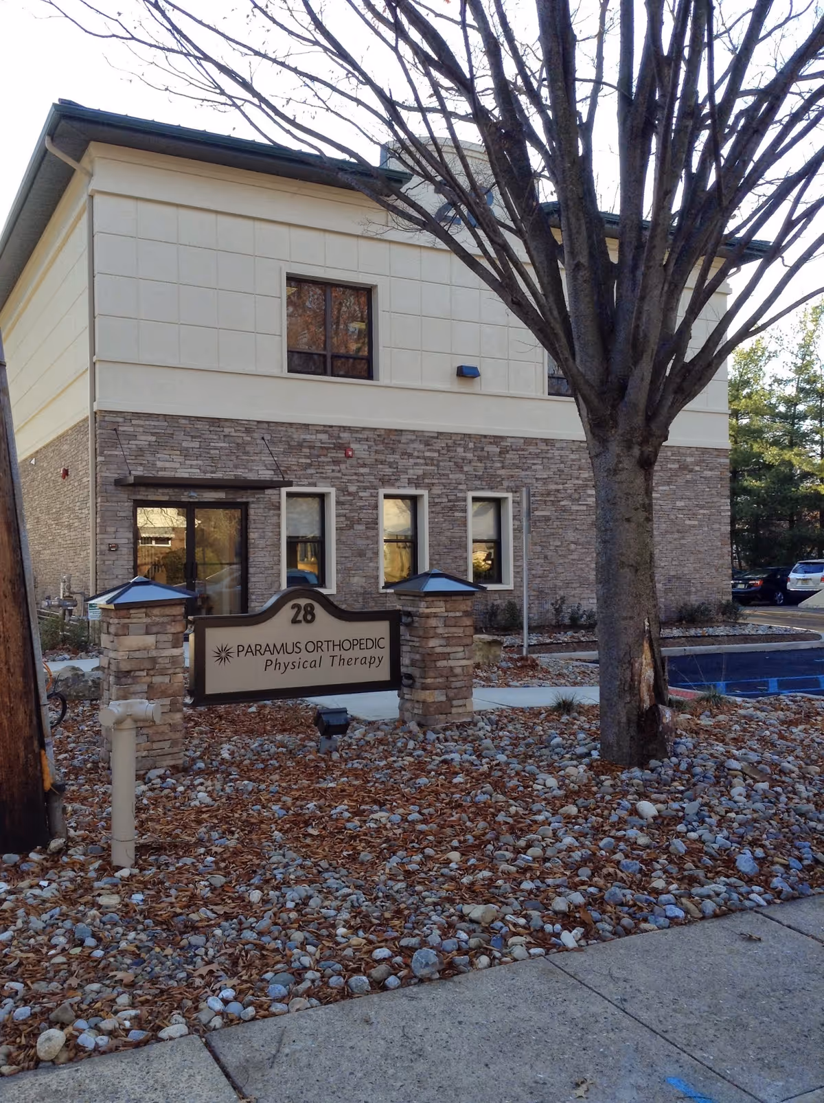 Exterior view of a two-story building with a sign for Paramus Orthopedic Physical Therapy.
