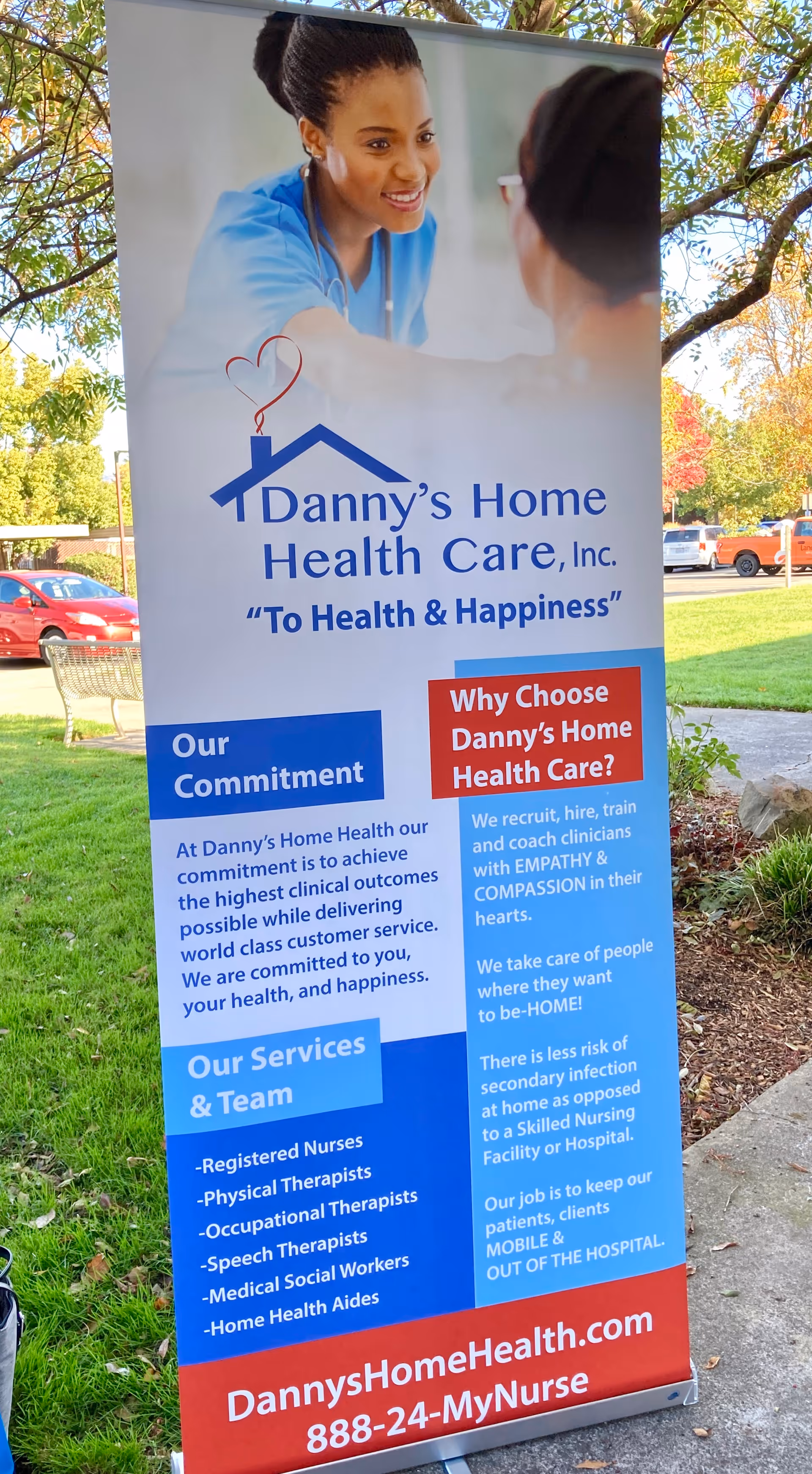 Prominent outdoor banner advertising Danny's Home Health Care with nurse image and contact details.