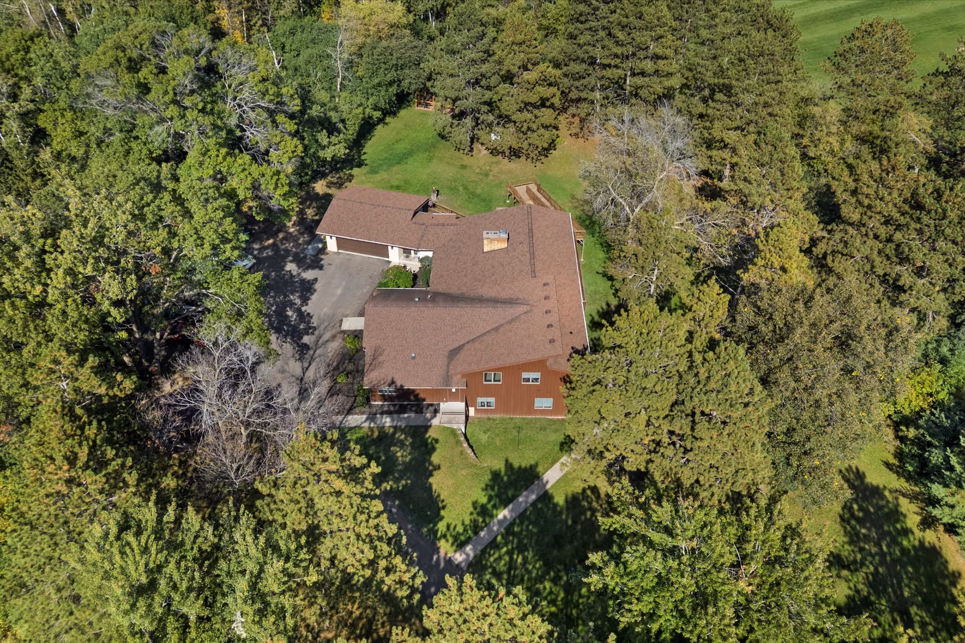 Aerial view of Legacy Pines Assisted Living & Memory Care building surrounded by dense trees.